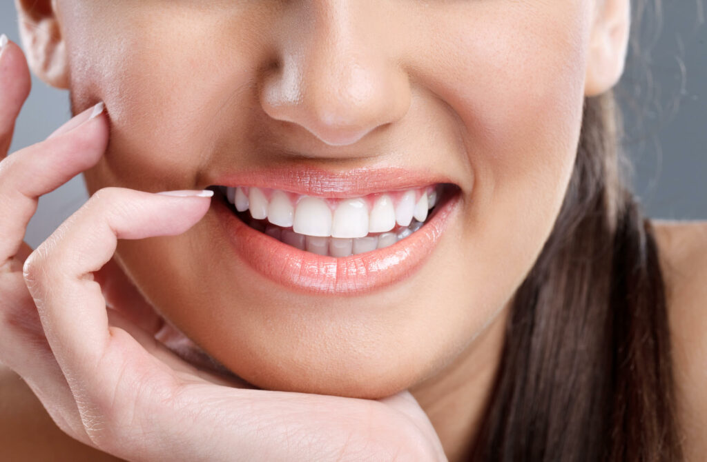 Close-up of woman's smile with healthy white teeth.