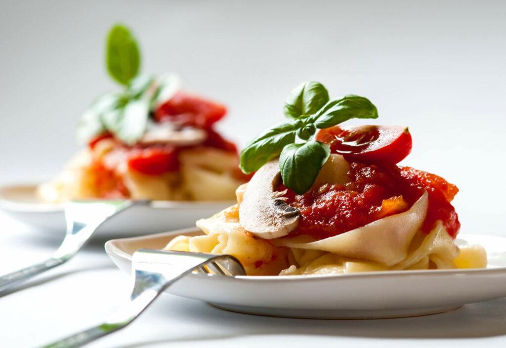 Fresh pasta with tomato sauce and basil.