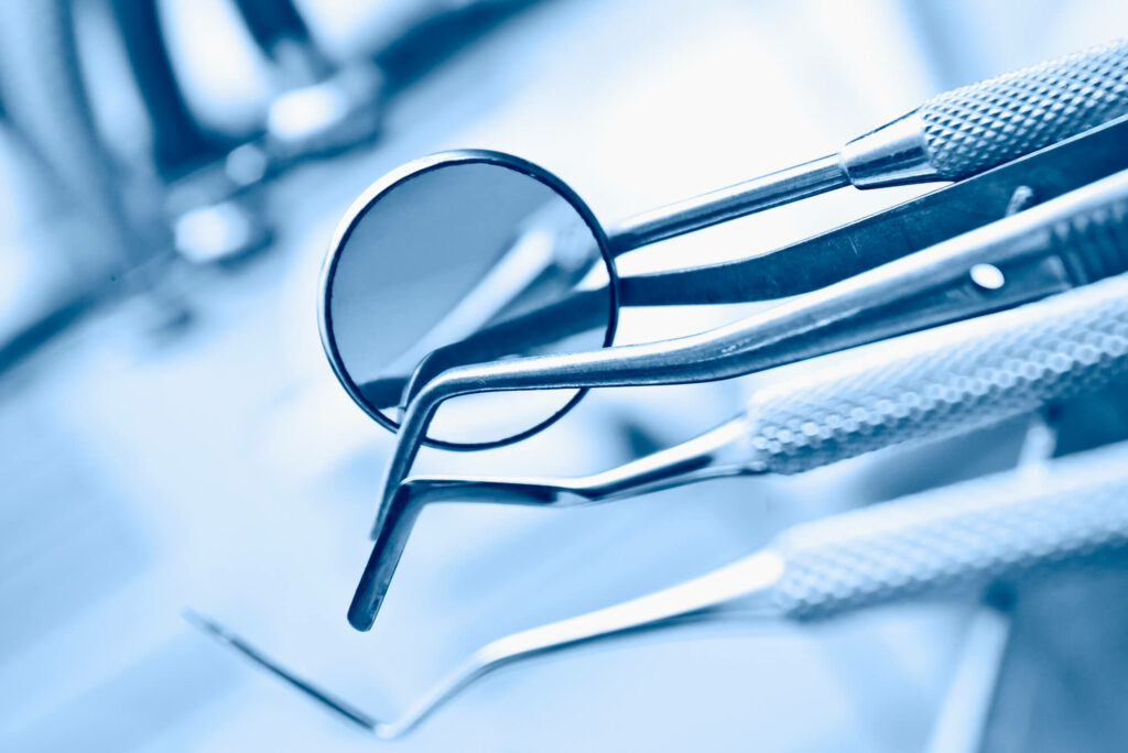 Dental instruments in blue tint for hygiene concept.